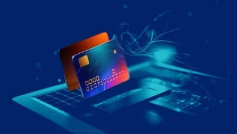 A credit card resting on a laptop keyboard, symbolizing online shopping or digital transactions.