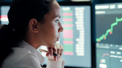 Professional analyzing data dashboards related to fraud reporting and intelligence sharing. 